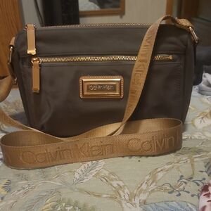 Calvin Klein Dark Brown Messenger Bag with Guitar Strap. Small Tear Inside